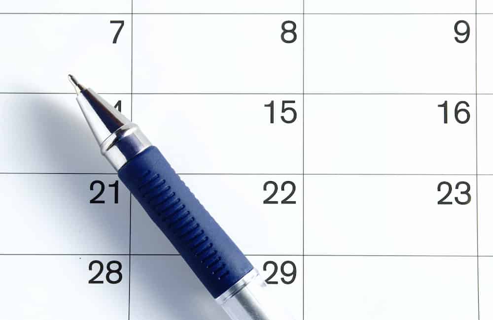 A calendar with a pen laid on top used to log projects for IT clients in Alberta. 