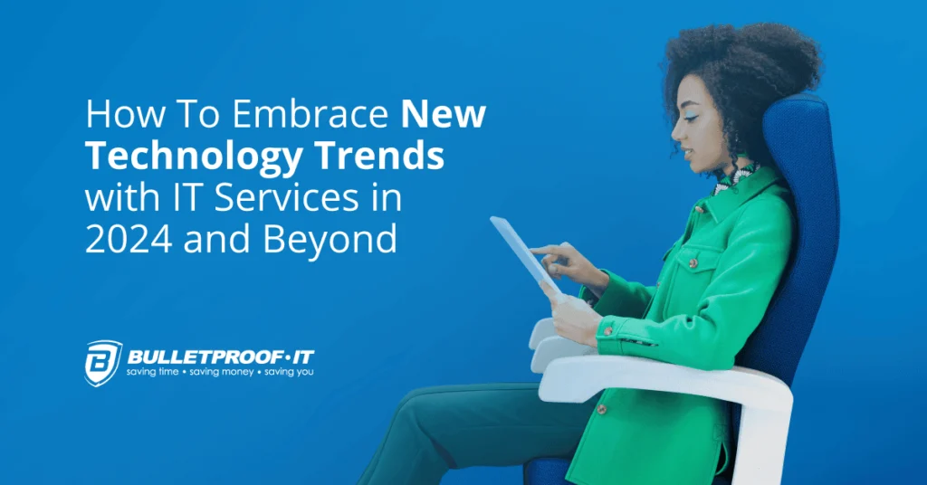 A woman with curly hair, wearing a bright green jacket, is sitting in a blue office chair and intently using a tablet. The background is a solid blue, with text on the left reading 'How To Embrace New Technology Trends with IT Services in 2024 and Beyond' above the Bulletproof-IT logo.
