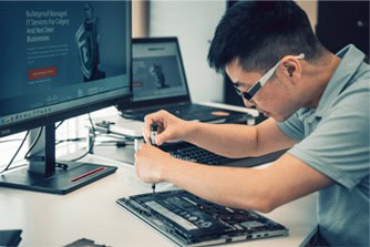 Bulletproof IT Technician working on a client laptop